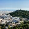 a city with trees and a hill