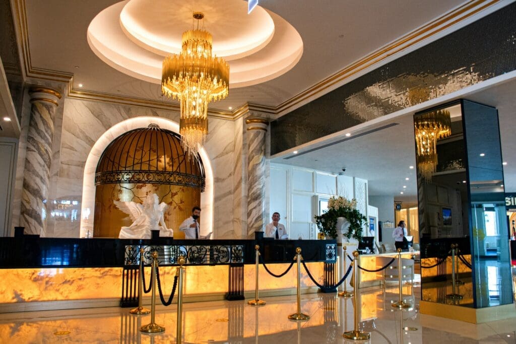 a hotel reception desk with a chandelier