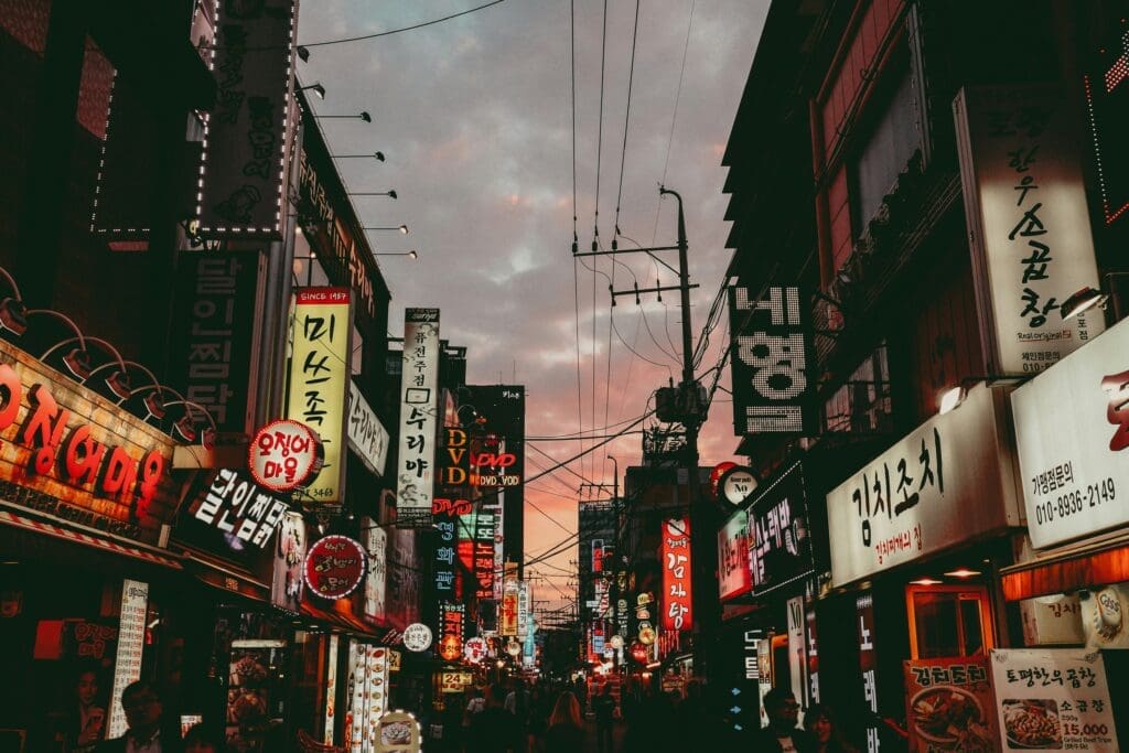 a street with signs and people walking in the city