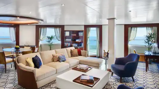a room with a couch and chairs