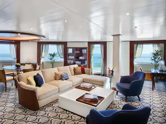 a room with a couch and chairs