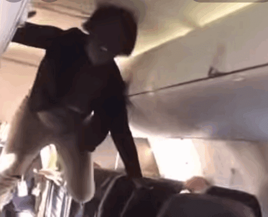 a person from the ceiling of an airplane