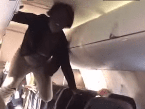 a person from the ceiling of an airplane