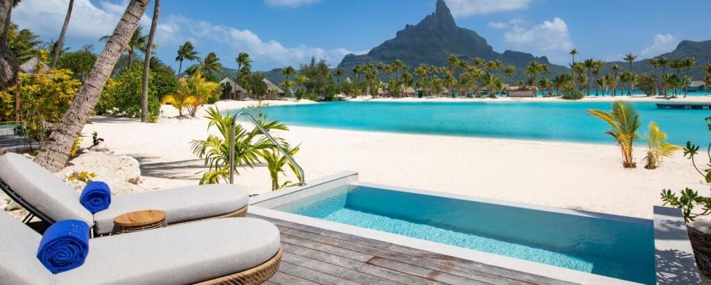 a pool with a chair and a mountain in the background