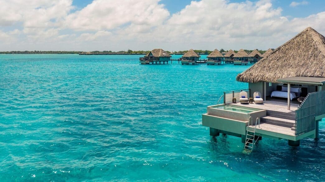 a group of huts on water
