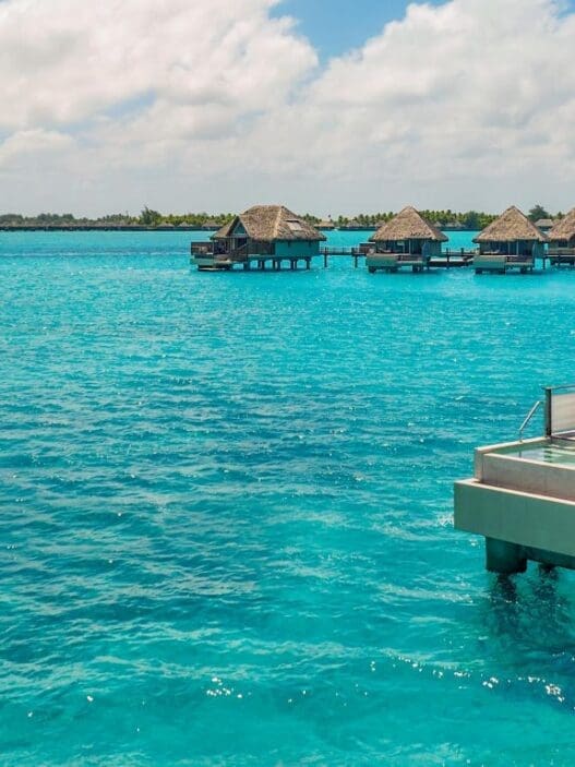 a group of huts on water