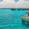 a group of huts on water