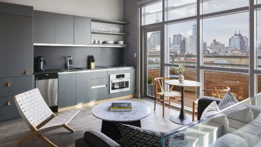 a living room with a kitchen and a table