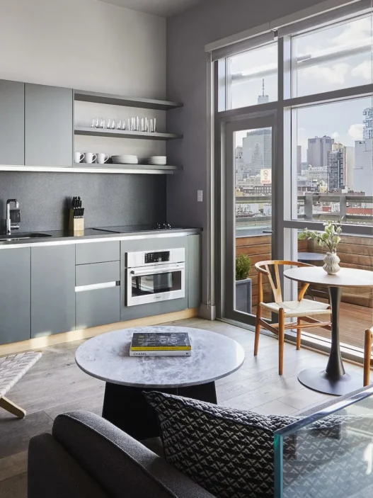 a living room with a kitchen and a table