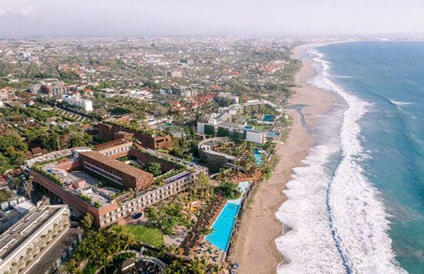 a beach with buildings and a pool