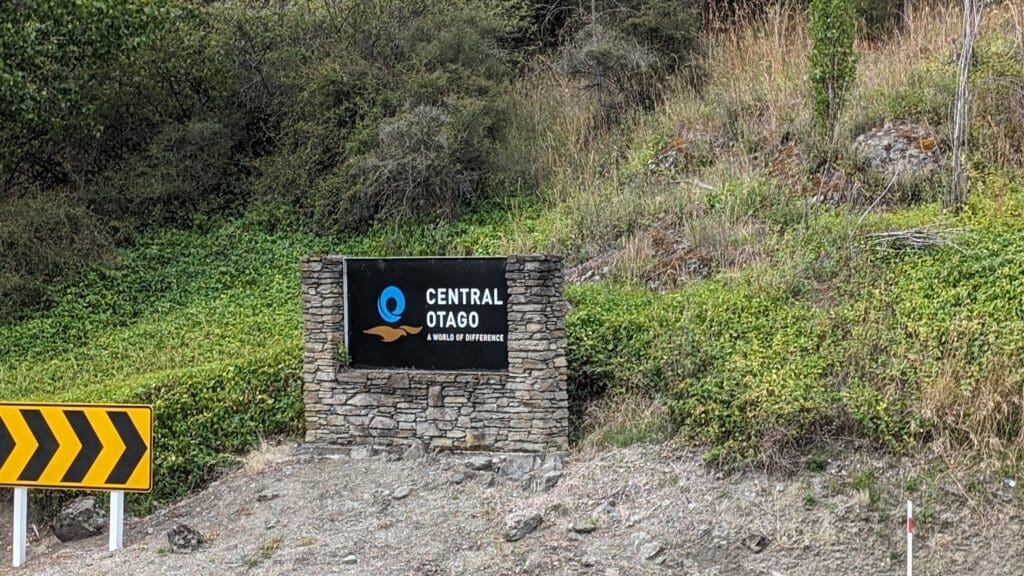 a sign on a stone wall