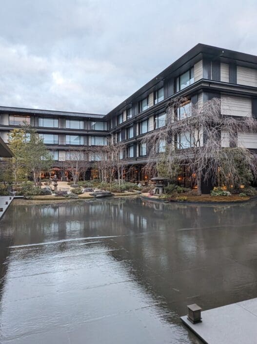 a building with a pond in front of it