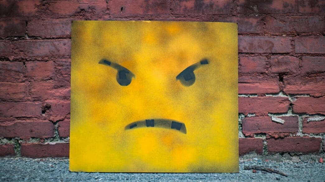 a yellow square with a face painted on it