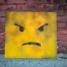 a yellow square with a face painted on it