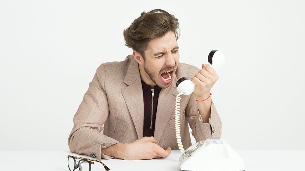 a man yelling at a telephone