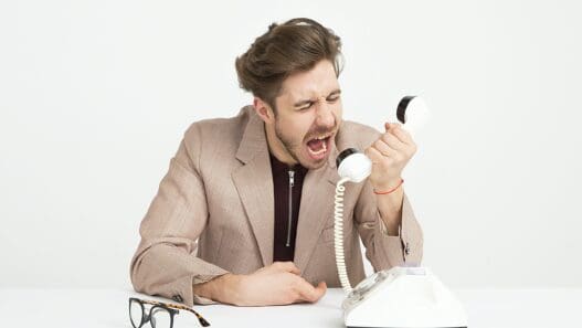 a man yelling at a telephone