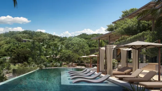 a pool with lounge chairs and trees in the background