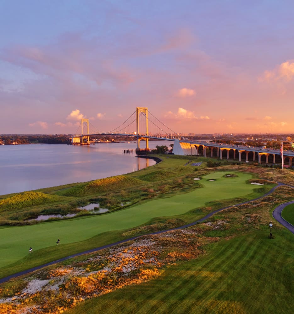 a golf course with a bridge over water