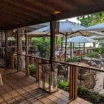 a patio with chairs and umbrellas