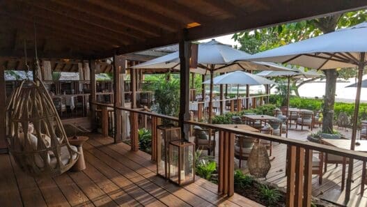 a patio with chairs and umbrellas