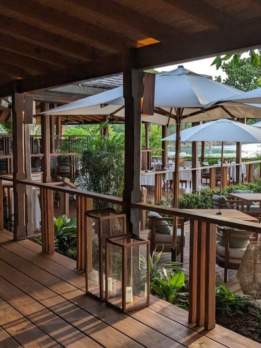 a patio with chairs and umbrellas