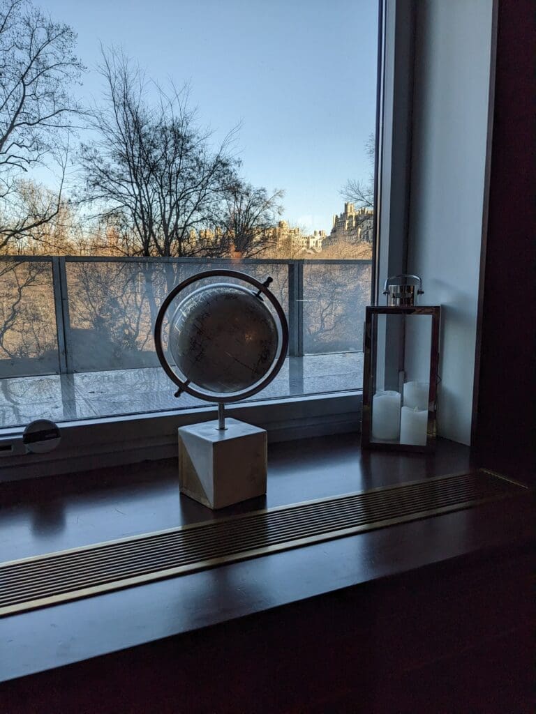 a globe on a table next to a window