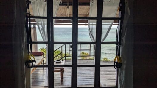 a glass door with a view of the ocean