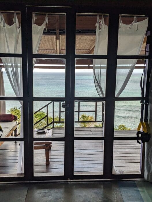 a glass door with a view of the ocean