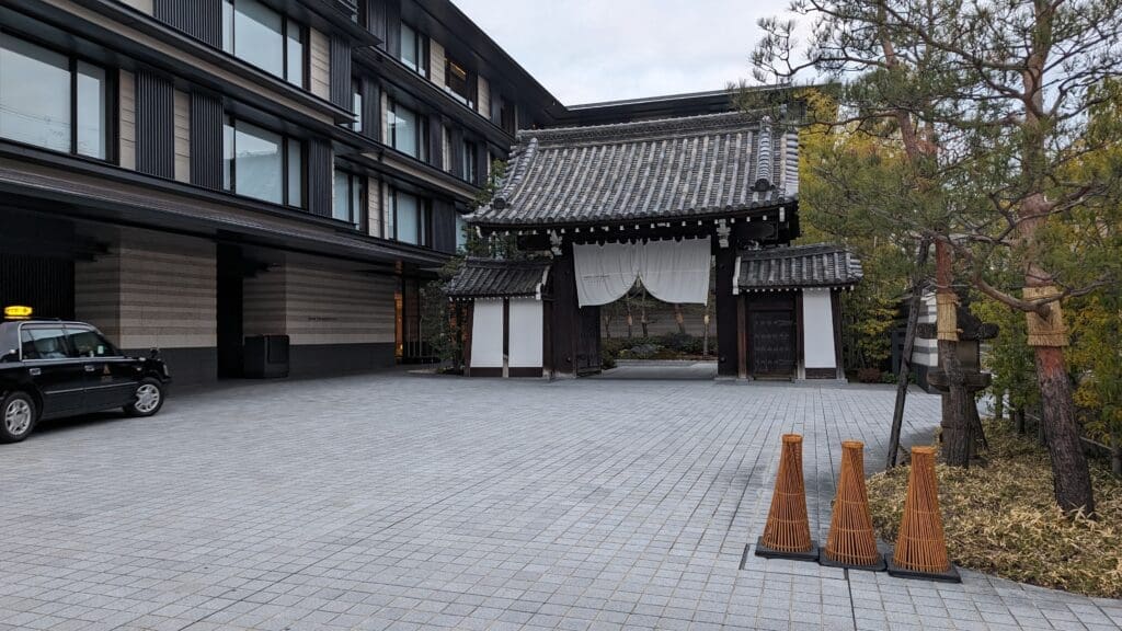 a building with a roof and a couple of cones in front of it