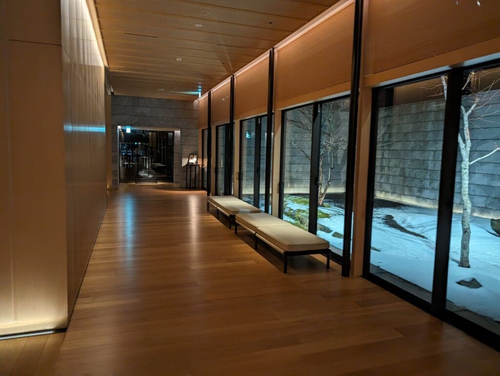 a long hallway with benches and windows