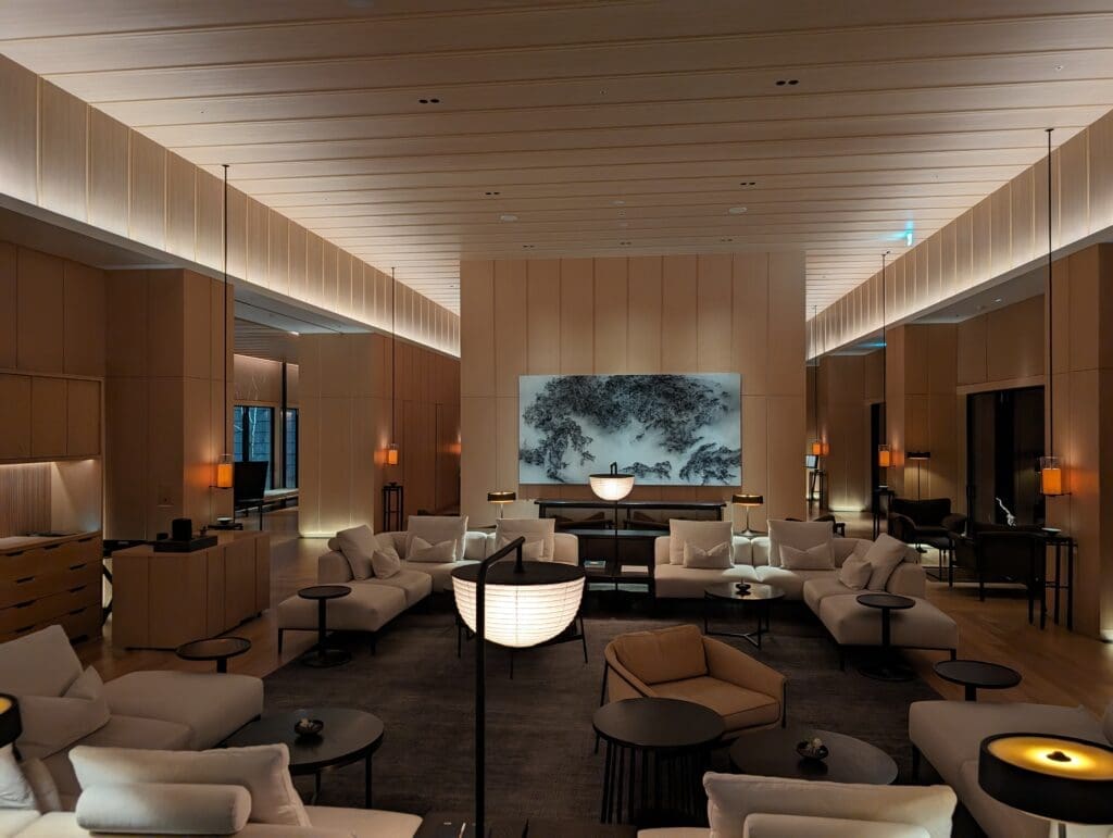 a room with white furniture and a large screen