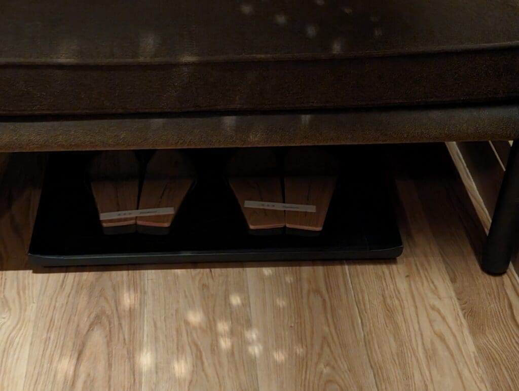 a pair of shoes under a couch