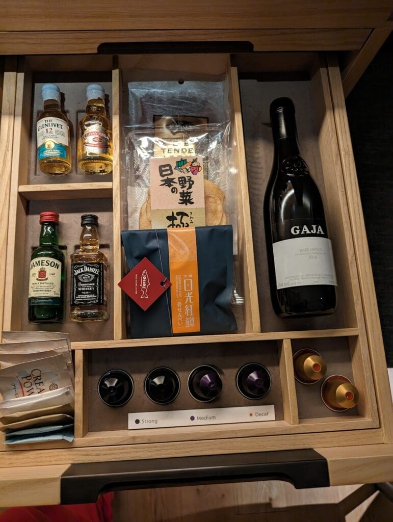 a wooden box with a bottle of alcohol and a package of food