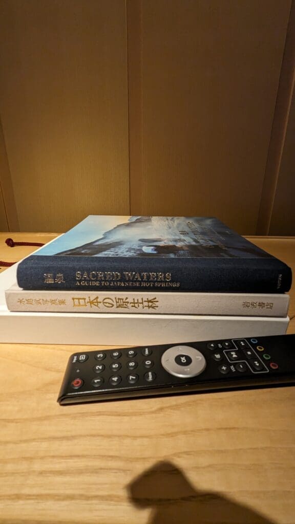a remote control next to a book
