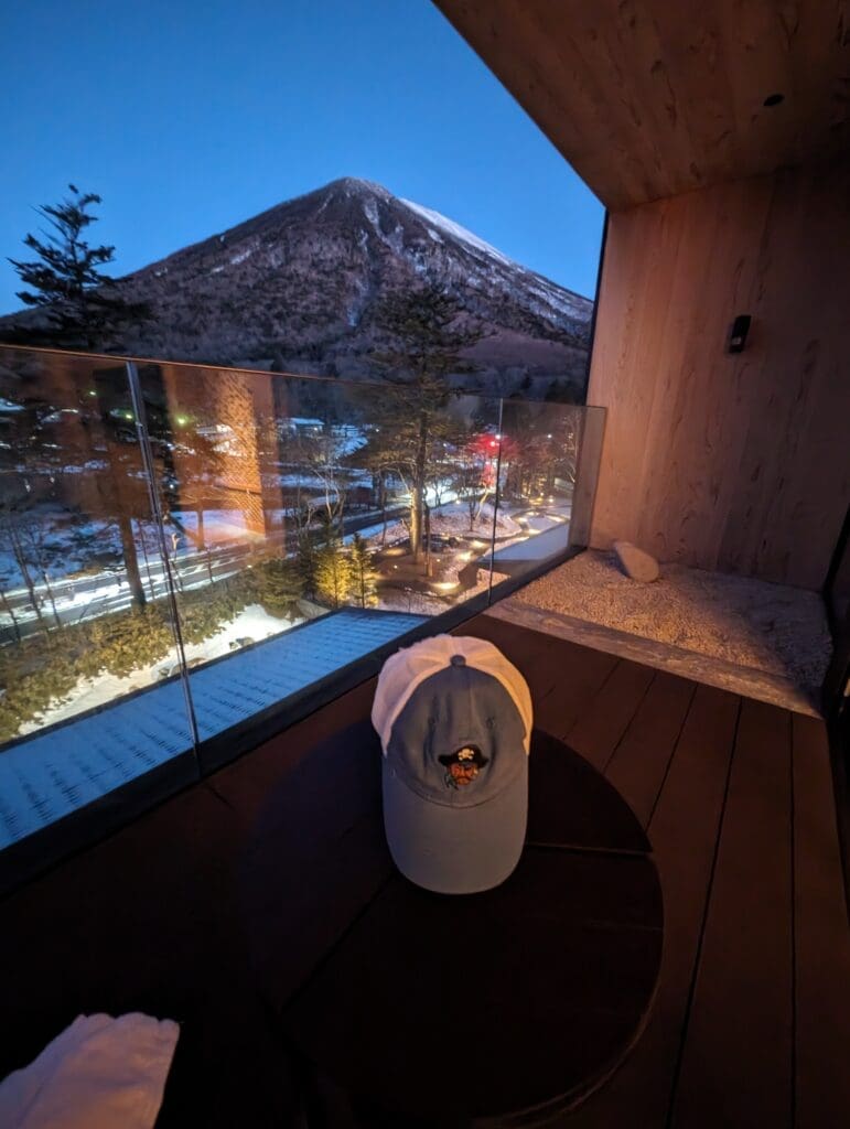 a hat on a deck overlooking a mountain