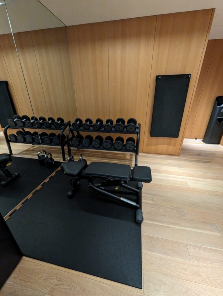 a gym with weights and a rack of weights