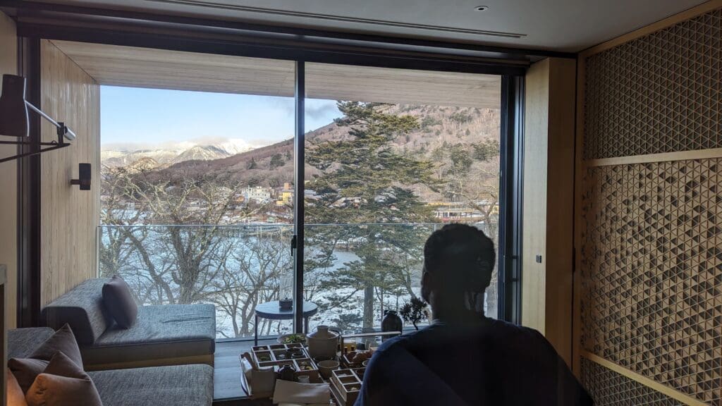 a person sitting at a table looking out a window