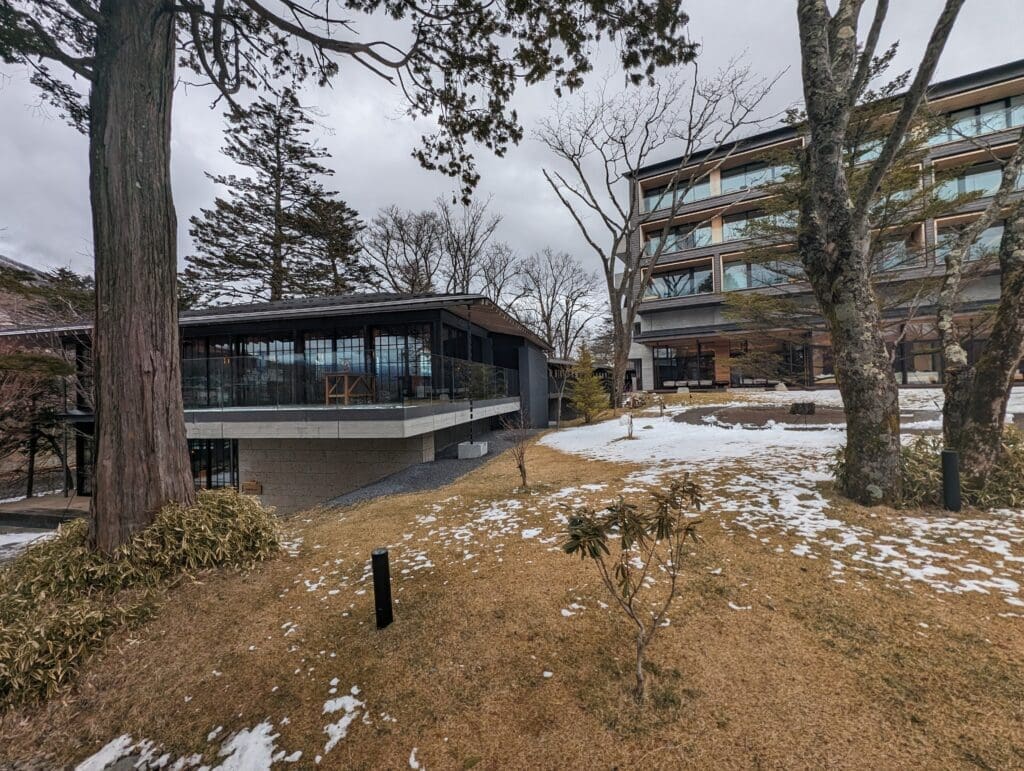 a building with a glass roof and a tree in front of it