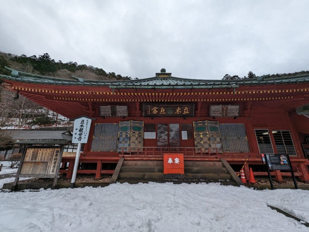 a building with a roof and snow