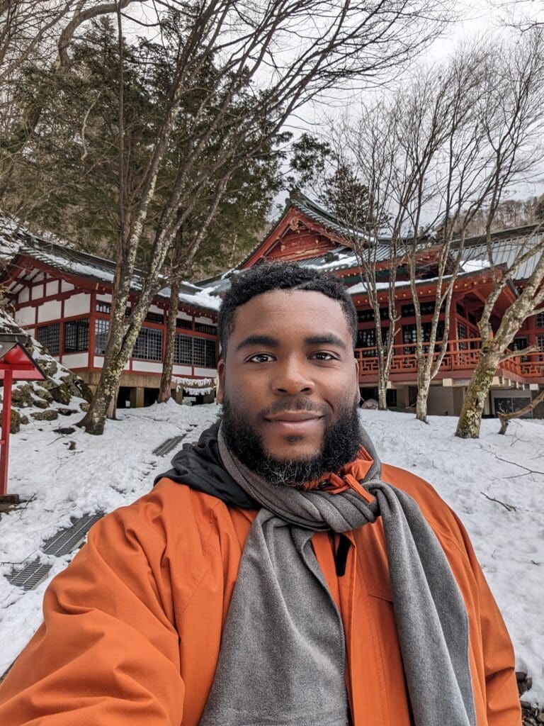 a man taking a selfie in front of a building