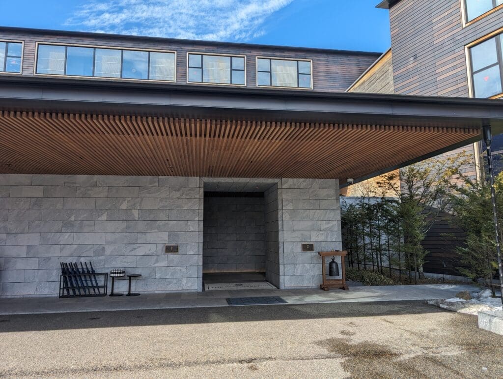 a building with a stone wall and a stone wall with a wood roof
