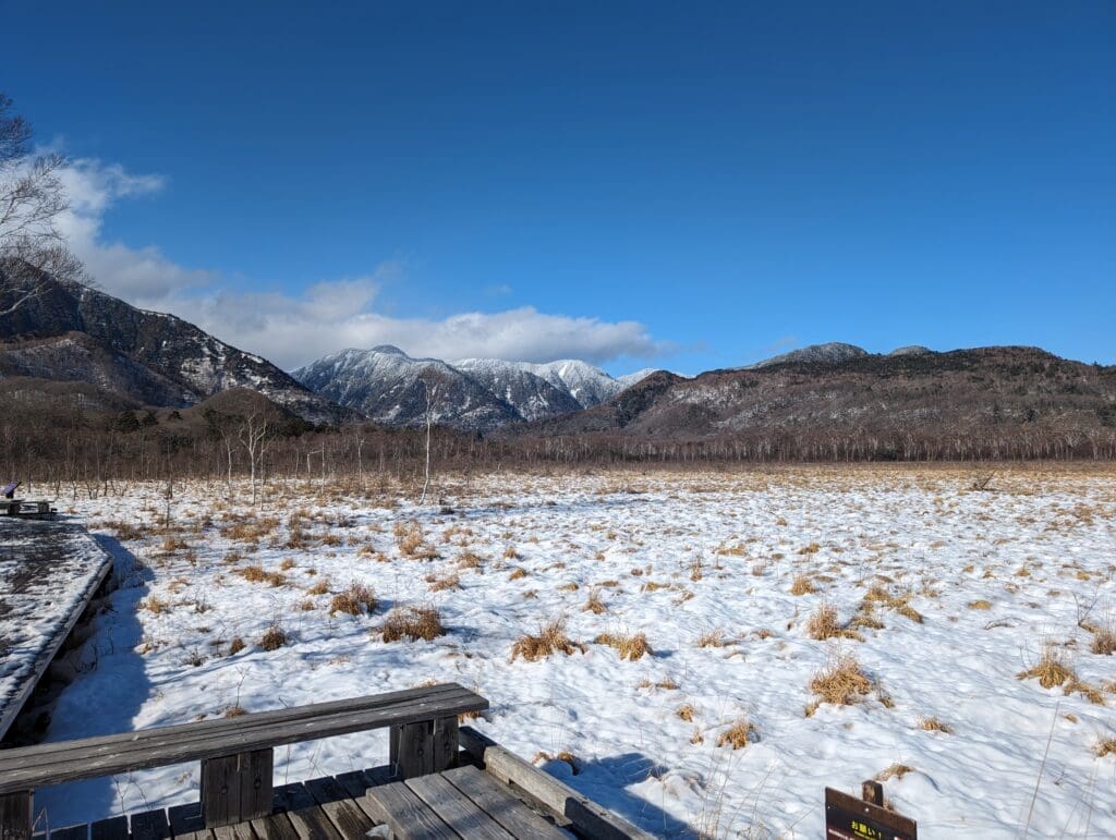 a snowy field with a wooden deck