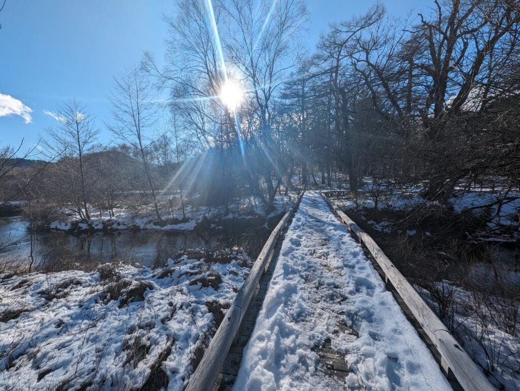 a snow covered bridge over a river