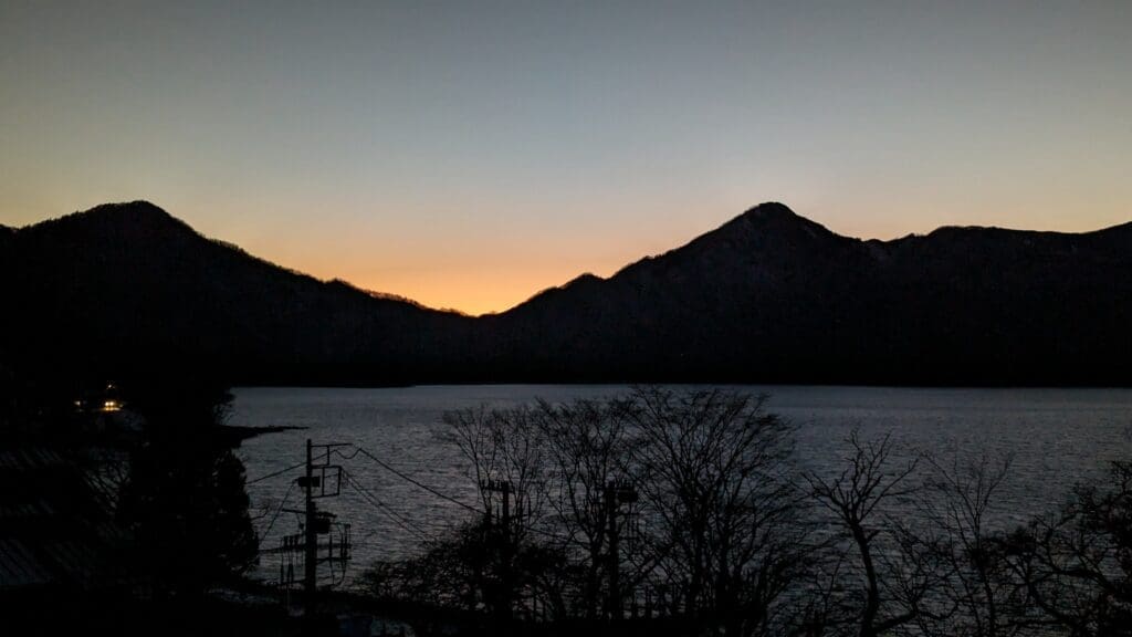 a body of water with mountains in the background