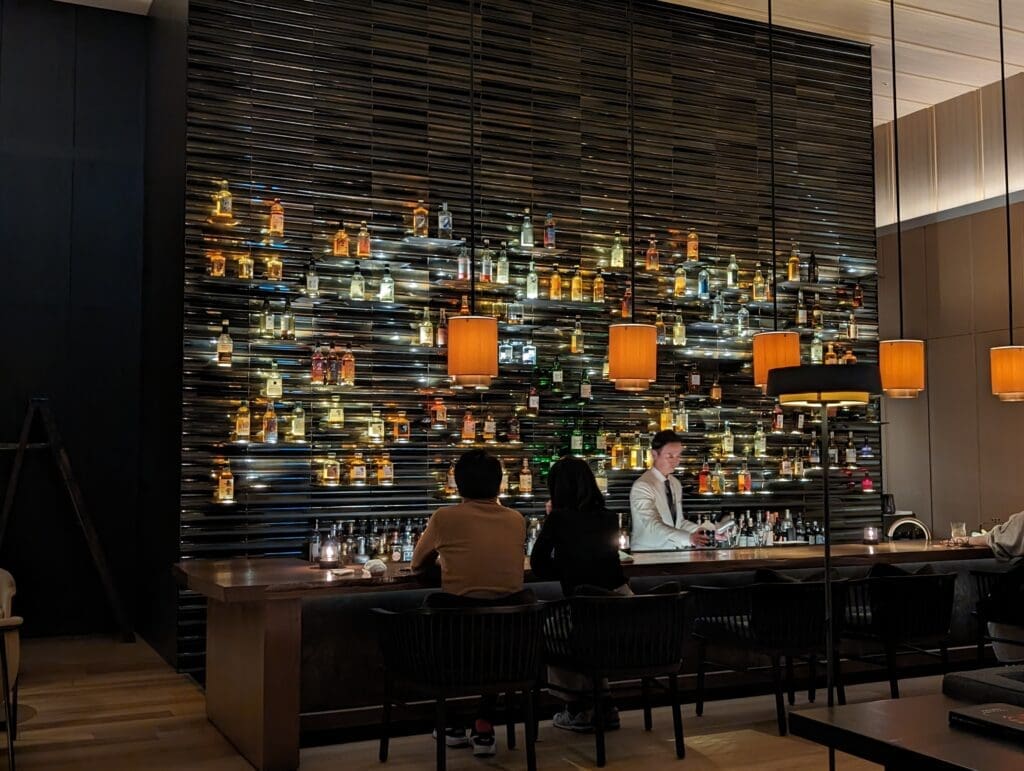 a group of people sitting at a bar