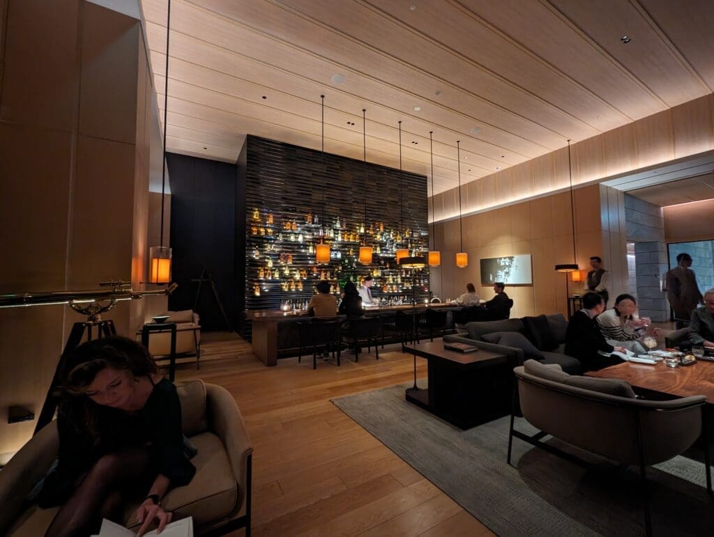 a room with a bar and people sitting around it