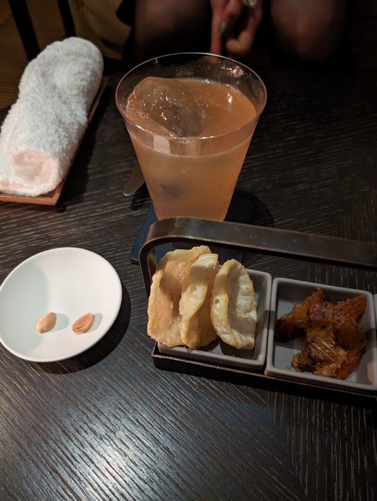 food in a tray and a glass of liquid