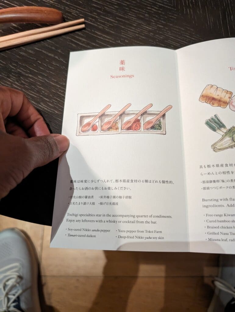 a hand holding a menu