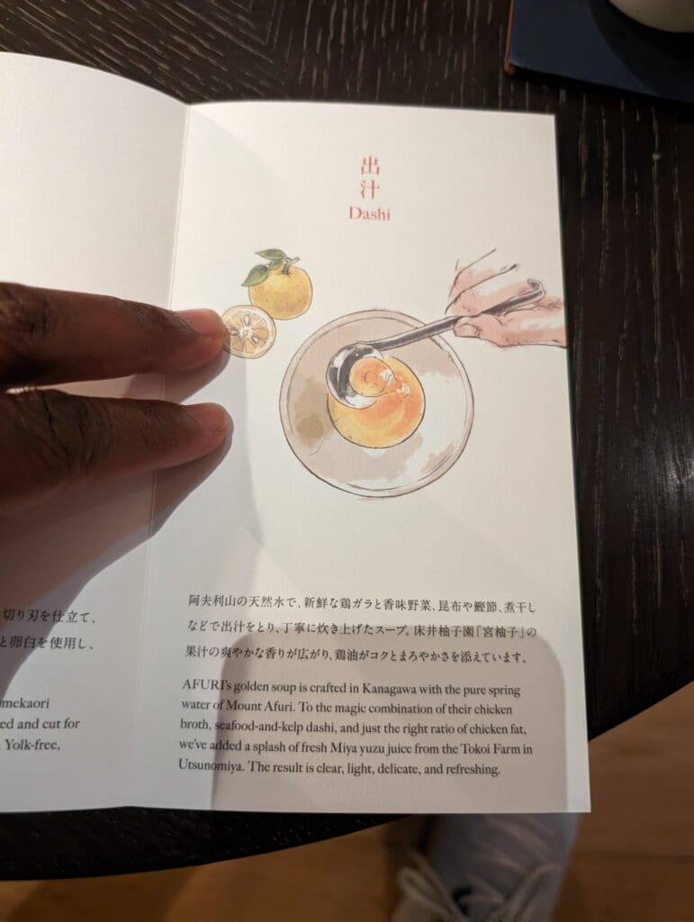 a hand holding a menu