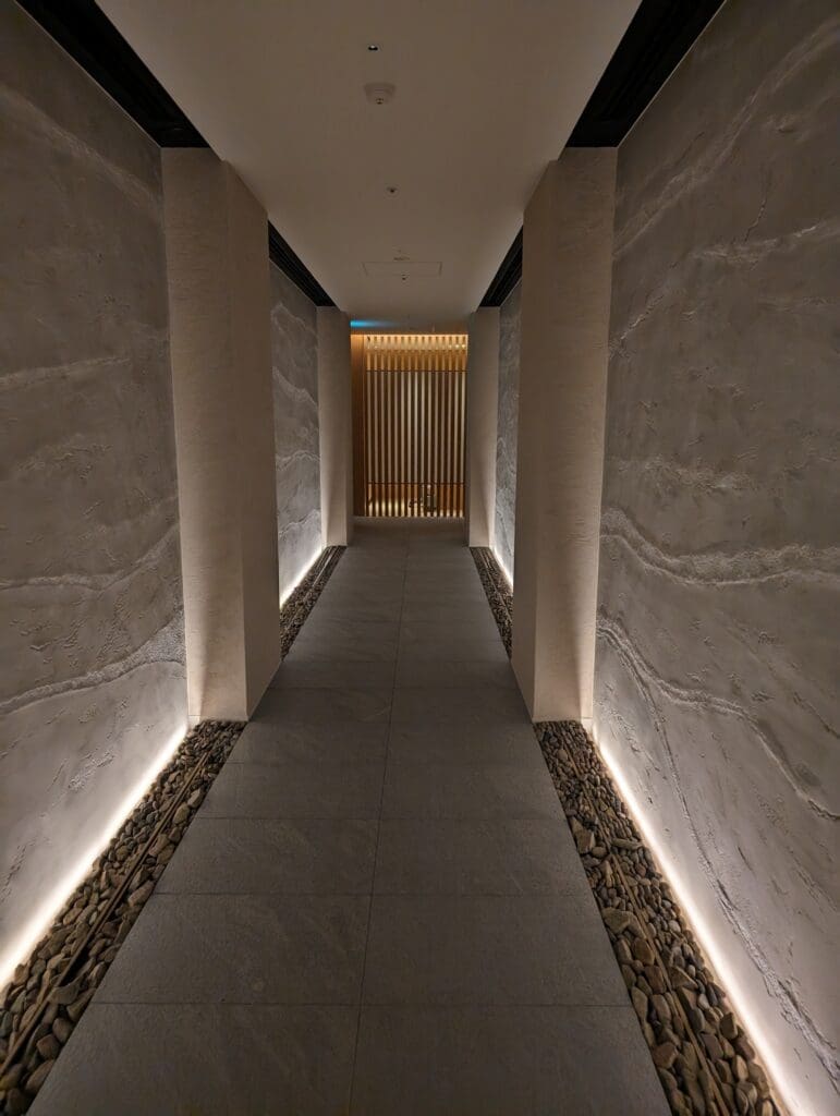 a hallway with stone walls and lights
